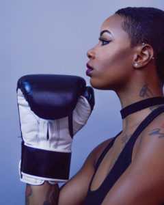 black female athlete with boxing gloves and feirce stare
